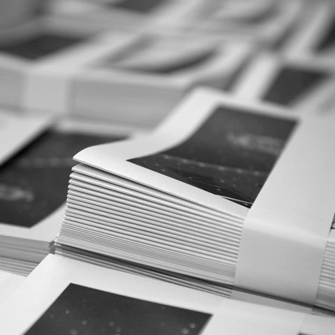 Stack of black and white booklets.