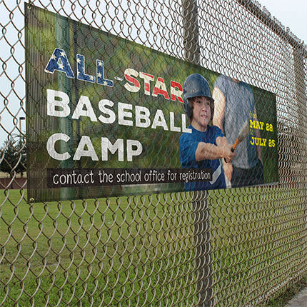 Full color baseball camp mesh banner mounted on fence.