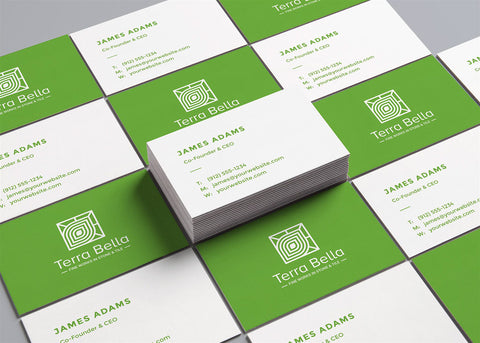 Green Pantone printed business cards laid out on flat surface.